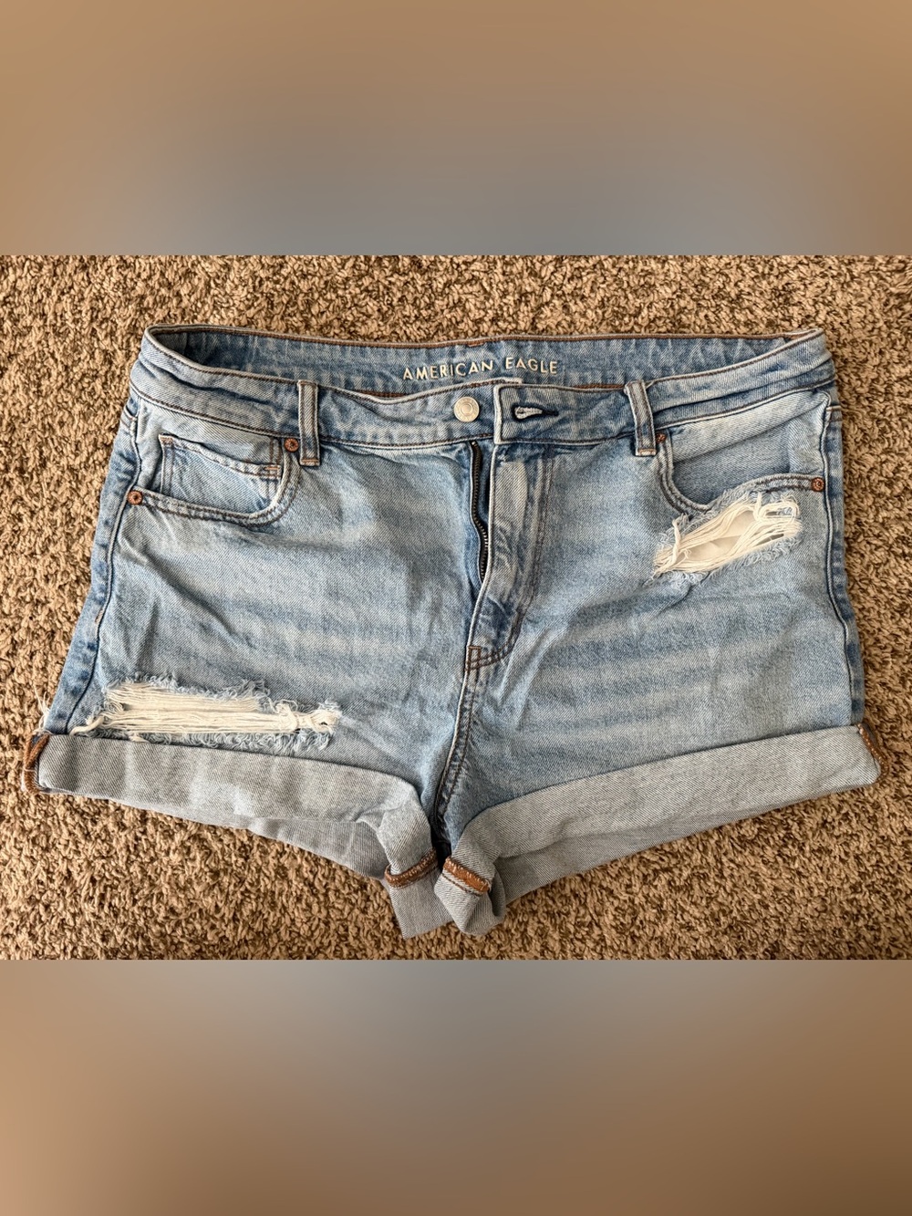 American Eagle light blue denim shorts with brown stitching